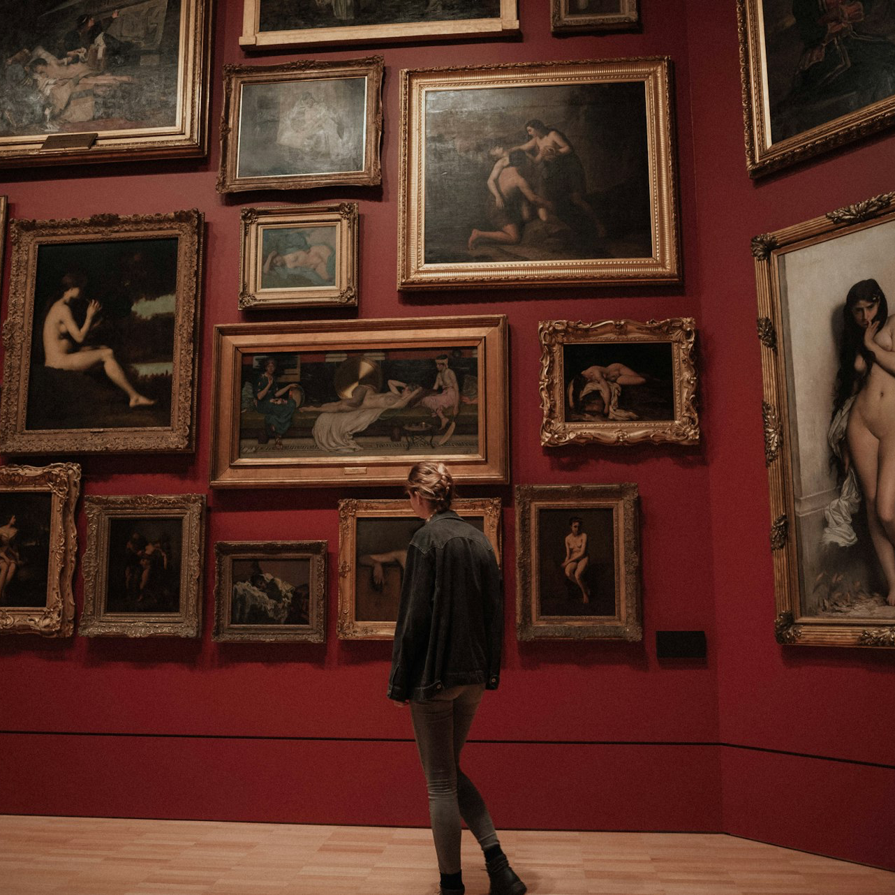 woman standing in front of paintings